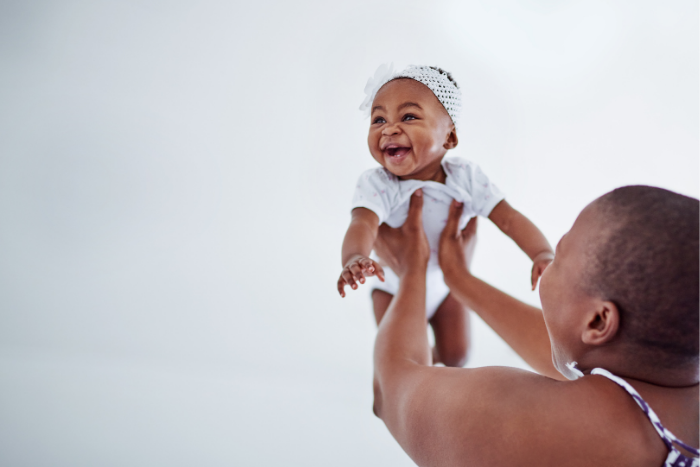 Woman of Color holding a baby