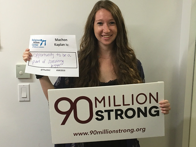 Rachel Kahn holding sign; 90 million strong to abolish the death penalty