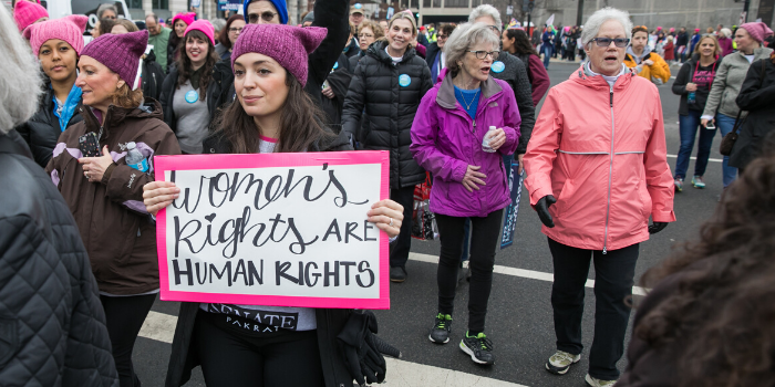 Woman with sign that says "Women's Rights are Human Rights"