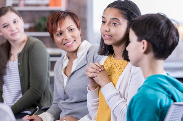 Students in a discussion with adults