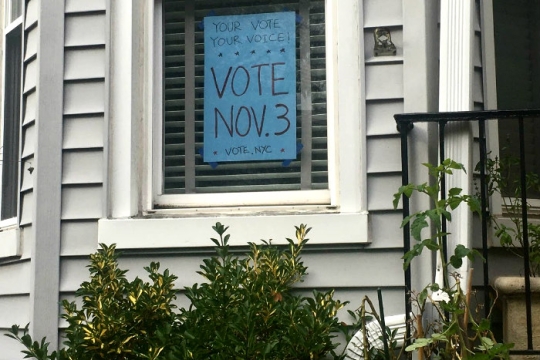 Handmade sign in a home window encouraging New Yorkers to vote on Nov 3