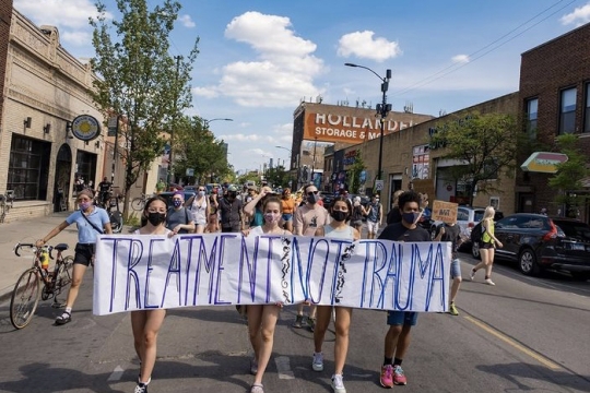treatement not truama poster at chicago area march