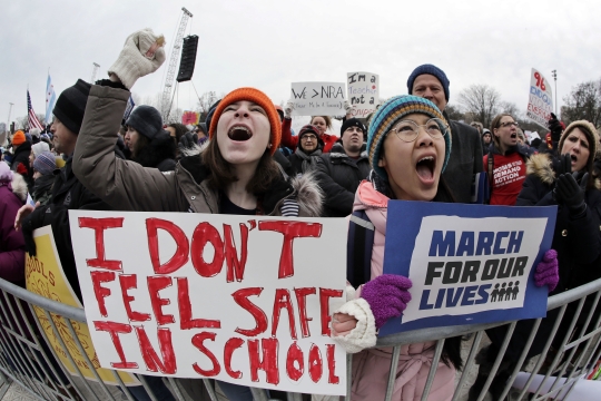 Teenagers holding signs at the March for our Lives